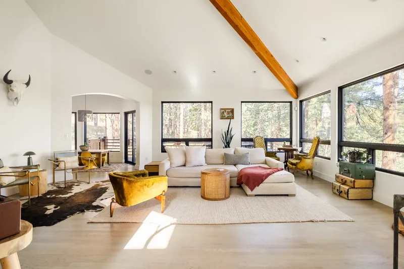 Vaulted living room with forest views in a boutique Colorado stay