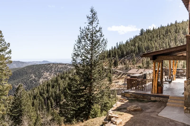 Covered mountain deck overlooking a Colorado pine valley
