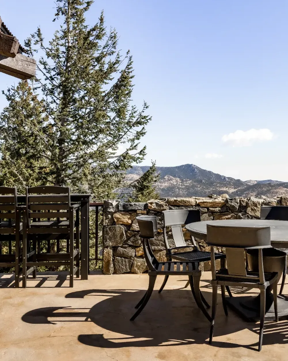 Covered timber deck with dining table and mountain view at a Colorado rental