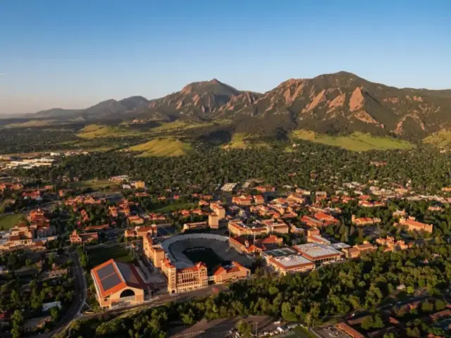 Aerial view of Boulder, Colorado with the Flatirons rising behind the city