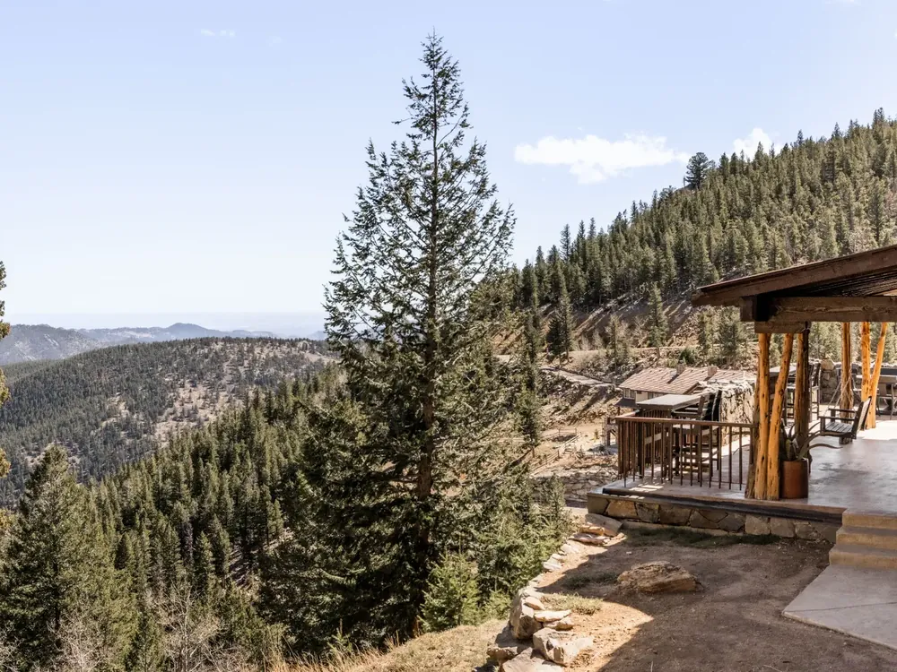 Covered mountain deck overlooking a Colorado pine valley