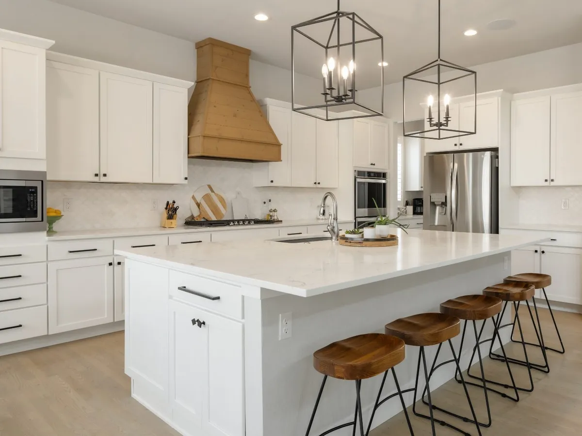 Guest-ready white kitchen with island seating after a StayReady turnover clean