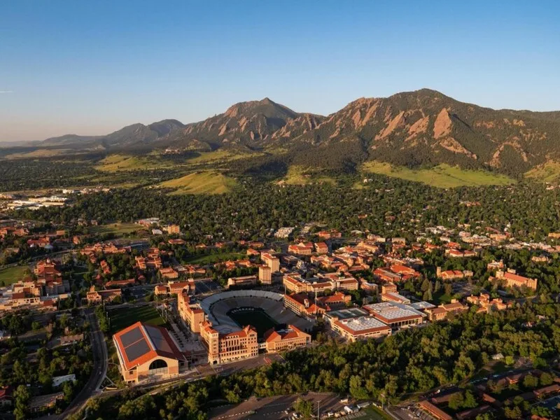Aerial view of Boulder, Colorado with the Flatirons rising behind the city