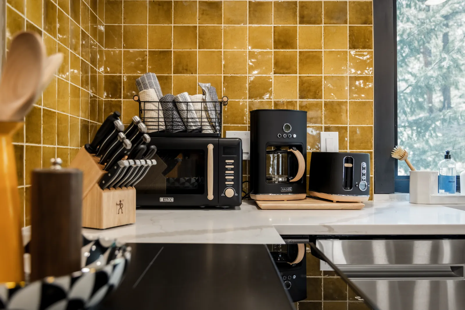Restocked guest amenities and supplies staged in a Colorado short term rental kitchen by StayReady restocking service