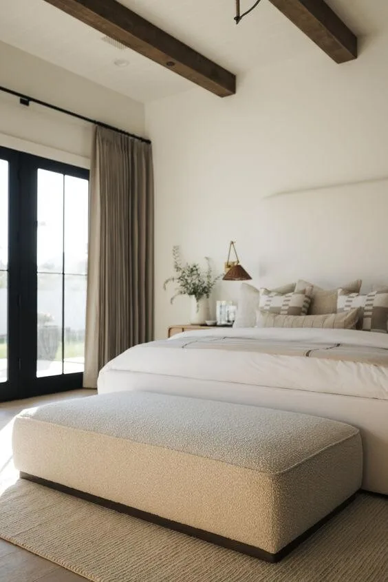 Colorado short term rental bedroom with wood ceiling beams, neutral linens, and natural light — a StayReady-prepared interior