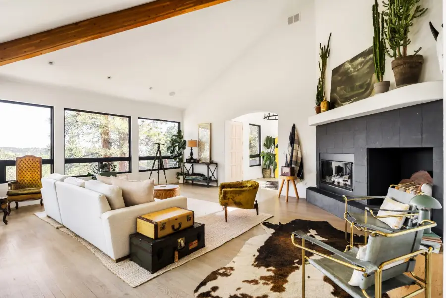 Colorado short term rental bedroom with wood ceiling beams, neutral linens, and natural light, a StayReady-prepared interior